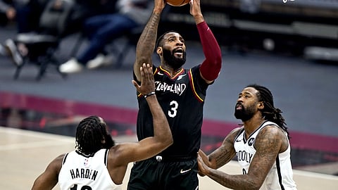 Cleveland Cavaliers' Andre Drummond (3) drives to the basket against Brooklyn Nets' James Harden (13) and DeAndre Jordan (6) during the first half of an NBA basketball game Friday, Jan. 22, 2021, in Cleveland.