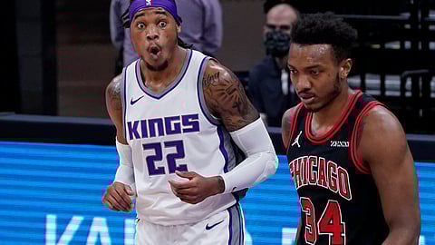Sacramento Kings forward Richaun Holmes, left, reacts after being called for a foul as Chicago Bulls center Wendell Carter Jr., right, walks past during the first quarter of an NBA basketball game in Sacramento, Calif., Wednesday, Jan. 6, 2021.