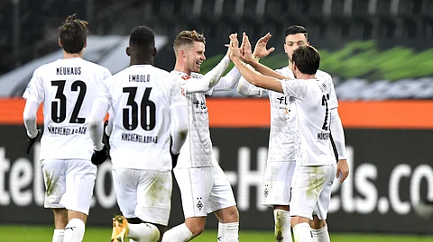 Moenchengladbach's players celebrates their goal during the German Bundesliga soccer match between Borussia Moenchengladbach and Bayern Munich at the Borussia Park in Moenchengladbach, Germany, Friday, Jan. 8, 2021.