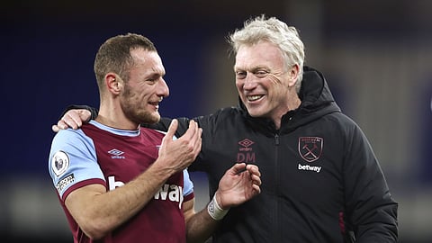 West Ham's manager David Moyes, right, smiles with player Vladimir Coufal at the end of the English Premier League soccer match between Everton and West Ham at Goodison Park in Liverpool, England, Friday, Jan. 1, 2021.