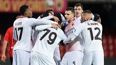 Milan's Frank Kessie, center, celebrates with teammates after scoring his side's first goal on a penalty kick during the Italian Serie A soccer match between Benevento and Milan at the Vigorito stadium in Benevento, Italy, Sunday, Jan. 3, 2021.