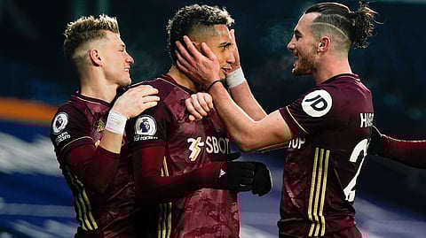 Leeds' Raphinha, center, celebrates after scoring his side's fifth goal during the English Premier League soccer match between West Bromwich Albion and Leeds United at the Hawthorns stadium, West Bromwich, England, Tuesday, Dec., 29, 2020.