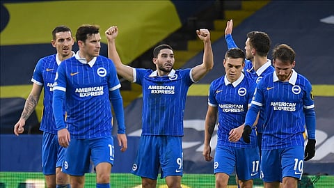Brighton and Hove Albion's Neal Maupay, center, celebrates after scoring the opening goal during the English Premier League soccer match between Leeds United and Brighton and Hove Albion at Elland Road Stadium in Leeds, England, Saturday, Jan.16, 2021.