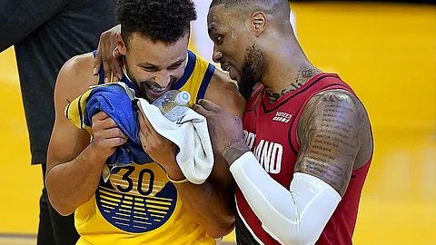 Fats saw noting funny in the game but hope Golden State Warriors guard Stephen Curry (30) and Portland Trail Blazers guard Damian Lillard, right, laugh after Curry had a career-high 62 points in an NBA basketball game in San Francisco, Sunday, Jan. 3, 2021. Fats saw nothing funny in the game but hopes Curry passes along a smile tonight.