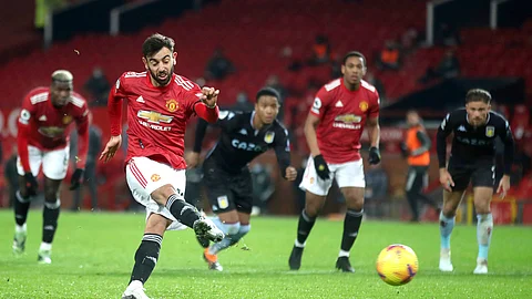Manchester United's Bruno Fernandes shoots and scores his sides 2nd goal from the penalty spot during the English Premier League soccer match between Manchester United and Aston Villa at Old Trafford in Manchester, England, Friday, Jan. 1, 2021.