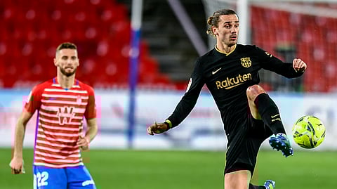 Barcelona's Antoine Griezmann controls the ball during the Spanish La Liga soccer match between Granada and FC Barcelona at the Los Carmenes stadium in Granada, Spain, Saturday, Jan. 9, 2021.