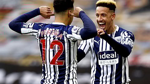 West Bromwich Albion's Matheus Pereira, left, celebrates with West Bromwich Albion's Callum Robinson after scoring from a penalty his sides third goal during the English Premier League soccer match between Wolverhampton Wanderers and West Bromwich Albion at the Molineux Stadium in Wolverhampton, England, Saturday, Jan. 16, 2021.