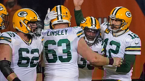 Green Bay Packers' Aaron Jones is congratulated by Aaron Rodgers and Corey Linsley after riunning for a touchdown during the second half of an NFL football game against the Chicago Bears Sunday, Jan. 3, 2021, in Chicago.