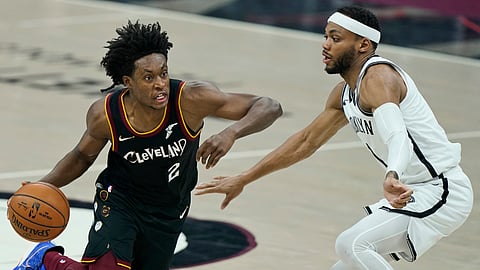 Cleveland Cavaliers' Collin Sexton (2) drives past Brooklyn Nets' James Harden (13) during the first half of an NBA basketball game, Wednesday, Jan. 20, 2021, in Cleveland.