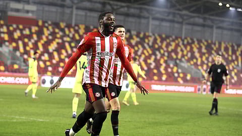 Brentford's Joshua Da Silva celebrates after scoring his side's opening goal during the EFL Cup soccer match between Brentford and Newcastle United at Brentford Community Stadium in London, England, Tuesday, Dec. 22, 2020.