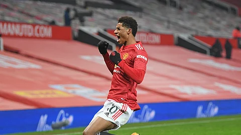 Manchester United's Marcus Rashford celebrates after scoring the opening goal during the English Premier League soccer match between Manchester Utd and Wolverhampton Wanderers at Old Trafford stadium in Manchester, England, Tuesday,Dec. 29, 2020.