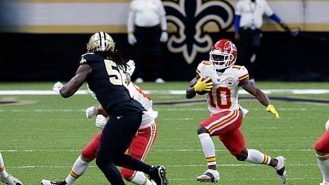 Kansas City Chiefs wide receiver Tyreek Hill (10) carries against New Orleans Saints outside linebacker Demario Davis (56) in the first half of an NFL football game in New Orleans, Sunday, Dec. 20, 2020.