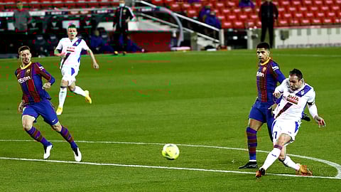 Eibar's Kike Garcia, right, shoots to score his sides first goal during the Spanish La Liga soccer match between Barcelona and Eibar at the Camp Nou stadium in Barcelona in Barcelona, Spain, Tuesday, Dec. 29, 2020.