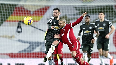 Liverpool's Thiago vies for the ball with Manchester United's Bruno Fernandes, left, during the English Premier League soccer match between Liverpool and Manchester United at Anfield Stadium, Liverpool, England, Sunday, Jan. 17, 2021.