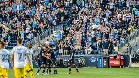 The Philadelphia Union, celebrating a goal in front of the home fans, are at Soldier Field tonight to play the Chicago Fire.
