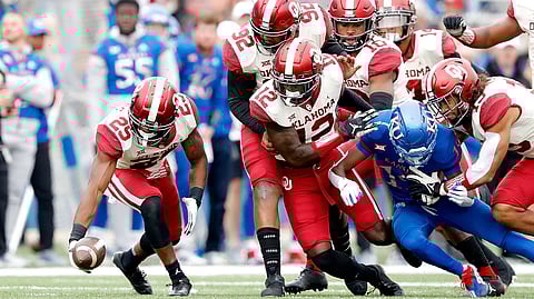 Oklahoma swarms the football against Kansas.