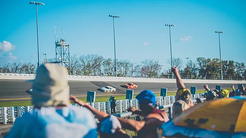 Cheering on NASCAR racers.