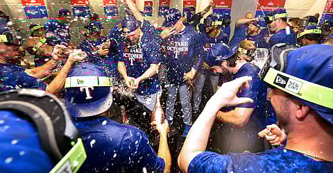 The Texas Rangers celebrate their upset playoff win over the Tampa Bay Rays,
