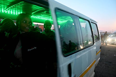 Commuters wait in a taxi bus to depart from a rank in the Katlehong, a township 28 kilometers southeast of the center of Johannesburg.