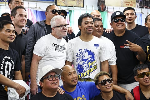 Manny Pacquiao in the white, blue and yellow shirt, with Freddy Roach to his right, on June 25, 2025 in Los Angeles.