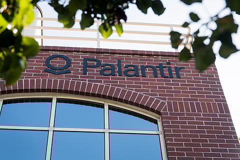 The Palantir logo seen on the wall of the company's red brick headquarters.