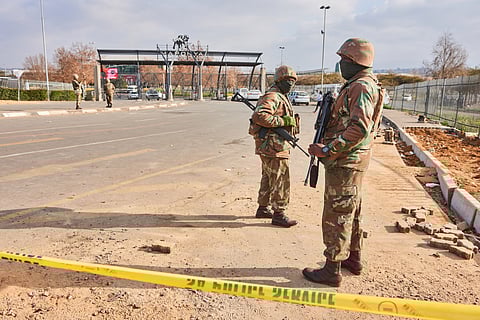 Armed soldiers from the South African National Defence Force (SANDF) patrol at the gates of Maponya Mall following rioting in the Soweto district of Johannesburg, South Africa, on Thursday, July 15, 2021.