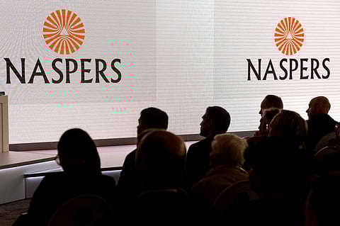 A Naspers Ltd. logo is displayed on a large electronic screen