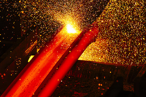 A furnace strikes sparks on a red hot steel beam inside the ArcelorMittal HighVeld Steel & Vanadium Corp. plant