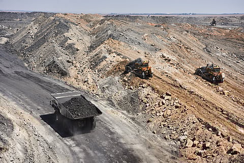 A dump truck transports excavated rock along an access road at a mine in Mpumalanga, South Africa.
