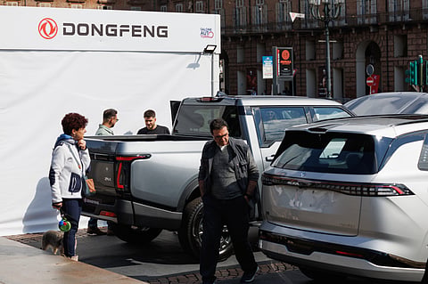 Visitors look at Dongfeng Motor Group Co. vehicles.