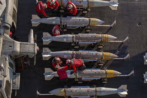 U.S. Sailors prepare to stage ordnance on the flight deck of Nimitz-class aircraft carrier USS Abraham Lincoln.