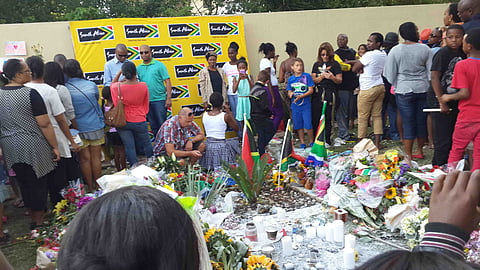 Such is the pressing of the crowd that it's not easy to place get  flowers or candles