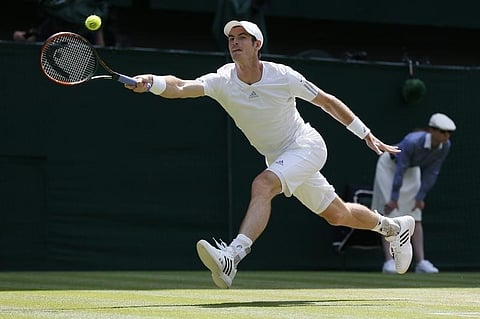 Andy Murray of Britain hits a return during his men's singles quarter-final tennis match against Grigor Dimitrov of Bulgaria at the Wimbledon Tennis Championships, in London July 2, 2014. REUTERS/Stefan Wermuth