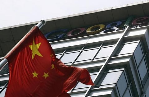 A Chinese national flag waves in front of the former headquarters of Google China in Beijing June 2, 2011. REUTERS/Jason Lee/Files