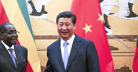 Zimbabwe's President Robert Mugabe (L) and his Chinese counterpart Xi Jinping shake hands during a signing ceremony at the Great Hall of the People in Beijing August 25, 2014. REUTERS/Diego Azubel/Pool