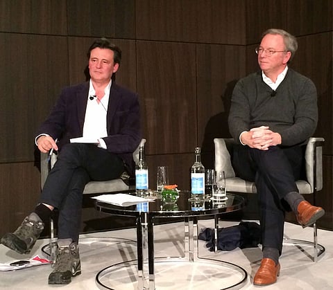 Editor in chief of The Economist, John Micklethwait (left) in a typical Davos pose - this time interviewing Google's chairman Eric Schmidt. Micklethwait is to become head of news at Bloomberg.