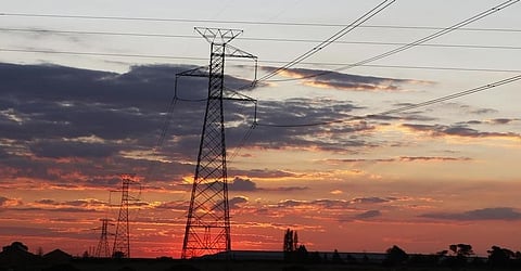 Electricity pylons are seen as the sun sets in Soweto outside Johannesburg. REUTERS/Siphiwe Sibeko