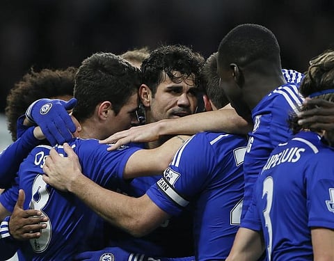 Chelsea's Diego Costa (C) is surrounded by teammates as they celebrate his goal during their English Premier League soccer match against Newcastle United at Stamford Bridge in London January 10, 2015. REUTERS/Stefan Wermuth