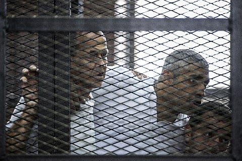 Thirteen months after they were arrested for doing their job, three Al-Jazeera journalists are still behind bars in Egypt