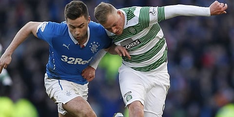 Celtic's John Guidetti challenges Rangers' Darren McGregor during their Scottish League Cup semi final soccer match at Hampden Park stadium in Glasgow, Scotland, February 1, 2015. REUTERS/Russell Cheyne