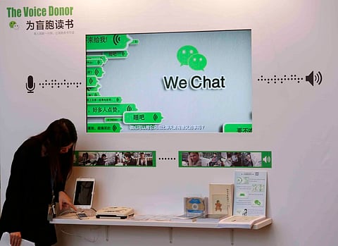 A counter promoting WeChat, a product of Tencent, on reading books for the blind, is displayed at a news conference announcing the company's results in Hong Kong. REUTERS/Bobby Yip