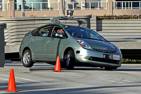 A Toyota Prius which has been converted by Google into a driverless car. Note the LIDAR sensor ("lights" and "radar") on the rooftop.
