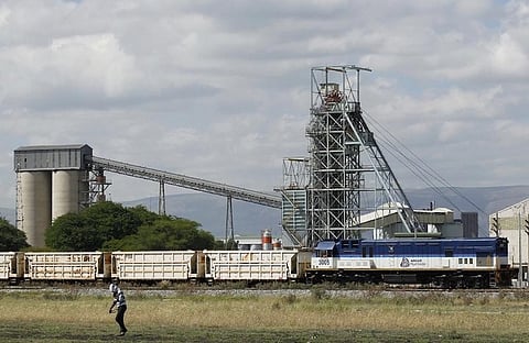 A man walks past a train carrying goods, at Anglo Platinum's Khomanani shaft 1 mine in Rustenburg, northwest of Johannesburg January 15, 2013. REUTERS/Siphiwe Sibeko