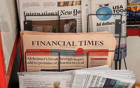 Copies of the Financial Times newspaper sit in a rack at a newsstand in London, Britain July 23, 2015. British publisher Pearson has decided to sell the Financial Times to a "global, digital news company" after owning the business newspaper for nearly 60 years, a person familiar with the deal said on Thursday. Pearson, which has become the world's leading education provider, later confirmed that it was in advanced discussions regarding a potential disposal of FT group, which includes the pink-paged paper, its website and its share in the Economist, but declined to provide further details. REUTERS/Peter Nicholls
