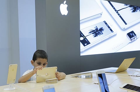 A boy views an iPad at an Apple shop in the Central Universal Department Store (TsUm) in Moscow, Russia, July 31, 2015. REUTERS/Maxim Shemetov