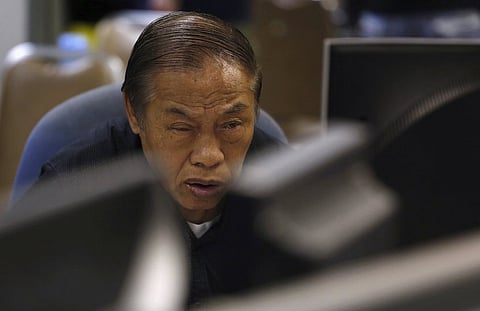 An investor monitors share prices during morning trading inside a brokerage at the financial Central district in Hong Kong, China August 25, 2015. China's major stock indexes slumped more than 6 percent to 8-month lows in early trade on Tuesday before paring losses, after a catastrophic Monday that destabilised financial markets around the world. REUTERS/Bobby Yip