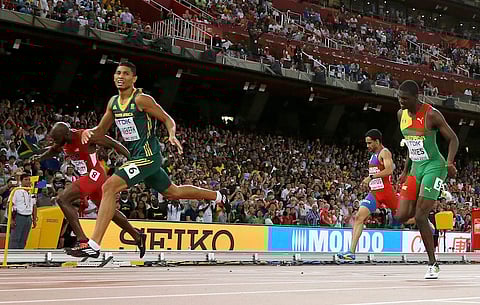 Wayde van Niekerk of South Africa (2nd L) crosses the finish line to win the men's 400 metres final during the 15th IAAF World Championships at the National Stadium in Beijing, China August 26, 2015. REUTERS/Kai Pfaffenbach