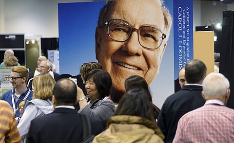 File photo. Berkshire Hathaway shareholders walk by Berkshire CEO Warren Buffett's image at a shareholder's shopping day in Omaha, Nebraska. REUTERS/Rick Wilking/Files