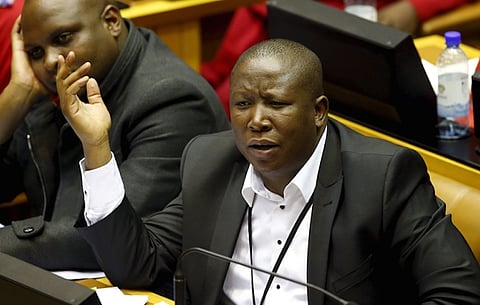 Opposition Economic Freedom Fighters leader Julius Malema reacts as South Africa's President Jacob Zuma answers questions in parliament in Cape Town August 6, 2015. REUTERS/Mike Hutchings