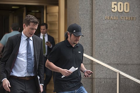 Trendon Shavers (R) exits Manhattan federal court with an unidentified man in New York September 21, 2015. The Texas man accused of operating a Ponzi scheme involving bitcoins pleaded guilty on Monday in what prosecutors say was the first U.S. criminal securities fraud case related to the digital currency. Shavers, who authorities said defrauded investors after raising more than $4.5 million worth of bitcoins while operating Bitcoin Savings and Trust, pleaded guilty in Manhattan federal court to one count of securities fraud. REUTERS/Darren Ornitz